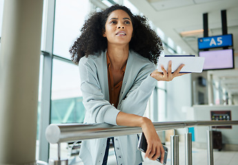 Image showing Black woman, ticket and confused at airport waiting for travel, departure or business trip. African American female traveler holding document, boarding pass or phone in missed airline or flight delay