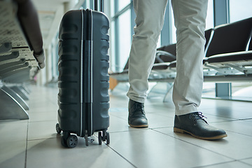 Image showing Airport, suitcase and person legs for travel, international opportunity or global journey walking in lobby. Luggage, bag and entrepreneur shoes or business man feet on vacation flight or hospitality