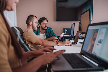 Image showing Programmers engrossed in deep collaboration, diligently working together to solve complex problems and develop innovative mobile applications with seamless functionality.