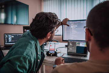 Image showing Programmers engrossed in deep collaboration, diligently working together to solve complex problems and develop innovative mobile applications with seamless functionality.