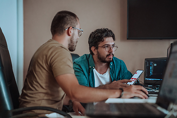 Image showing Programmers engrossed in deep collaboration, diligently working together to solve complex problems and develop innovative mobile applications with seamless functionality.