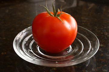 Image showing Fresh tomato on the glass plate.