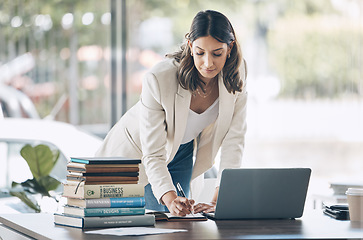 Image showing Woman, serious or laptop for notebook writing, marketing strategy review or global planning schedule in office. Worker, employee or notes for technology startup, calendar management or growth goals