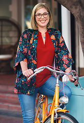 Image showing Portrait, bike and eco friendly with a woman cycling on vintage transport for travel or tourism abroad. Bicycle, riding or tourist with a young female cyclist in an urban town while overseas vacation