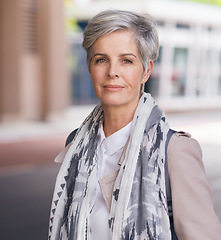 Image showing Portrait, elderly and business woman confident in an urban town or city travel for a startup company. Adventure, mature and senior female traveling international with serious face for tourism
