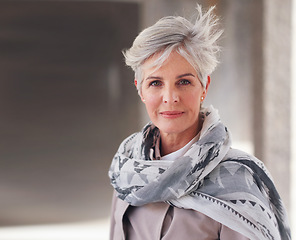 Image showing Portrait, travel and mature woman tourist with fashion or style in an urban town or city on vacation or holiday. Adventure, serious and face of elderly female on retirement traveling with mockup