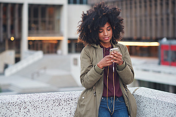 Image showing Black woman, city and texting with afro, smartphone ux and reading for social network chat. Urban gen z girl, african and phone for blog, post and networking on dating app on rooftop balcony in metro