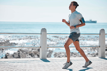 Image showing Fitness, running and man by ocean for exercise, marathon training and endurance workout in action. Sports mockup, motivation and male runner focus for wellness, healthy body and performance in Miami
