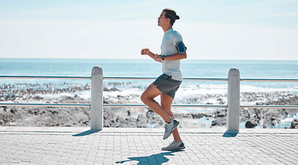 Image showing Fitness, sports and man running by ocean in action for wellness, performance and athlete endurance. Nature, motivation and male runner by sea for exercise jog, marathon training and cardio workout