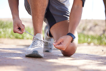 Image showing Fitness, exercise and man tie shoes ready to start running, marathon training and endurance workout. Sports, nature trail and feet of male runner tying shoelace for wellness, health and performance