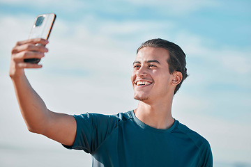 Image showing Fitness, man and exercise selfie on outdoor for social media, profile picture and workout vlog post. Sports person, runner and photograph with smile on blue sky, wellness goals and running motivation