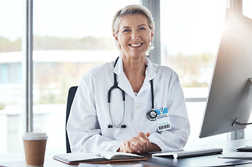 Image showing Healthcare, medicine and portrait of a doctor at a desk for medical work, cardiology and surgery. Happy, working and mature woman consulting in medicare, hospital research and expert consultation