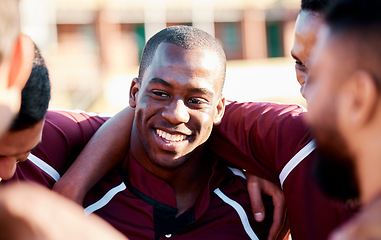 Image showing Sports, huddle and man athlete on a field for motivation or strategy planning with his team. Fitness, workout and happy African male rugby player talking with his sport group before a match or game.