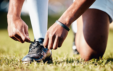 Image showing Man, hands and shoe tying laces getting ready for sports training, exercise or match and game on grass field. Hand of male in preparation, tie shoes and sport for fitness, start or soccer practice