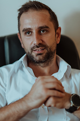 Image showing A successful businessman is sitting in his office after a hard day's work