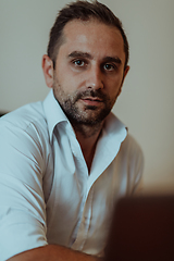 Image showing A successful businessman is sitting in his office after a hard day's work