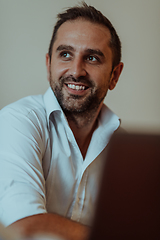 Image showing A successful businessman is sitting in his office after a hard day's work