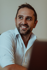 Image showing A successful businessman is sitting in his office after a hard day's work