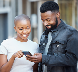 Image showing City, communication and couple browsing on a cellphone with social media, mobile app or the internet. Technology, 5g network and young African man and woman scrolling on a website with phone in town.