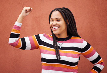 Image showing Flexing, smile and portrait of a strong black woman for empowerment isolated in studio brown background. Confident, excited and young fashion, style and female model proud to be African American