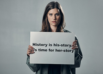 Image showing Protest, feminism and portrait of woman activist, poster in studio and mission isolated on grey background. Mockup, feminist and protesting in support of human rights, freedom and equality for women.