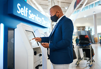 Image showing Covid, travel and self service with black man and phone in airport for online booking, ticket and technology. Vacation, business trip and kiosk with passenger typing for flight, airline and check in