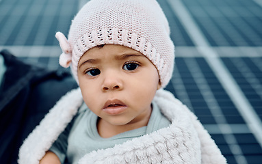 Image showing Portrait, baby and beanie with a girl child in a blanket during winter looking cute or adorable. Children, babies and face with a small female kid feeling curious or serious while keeping warm