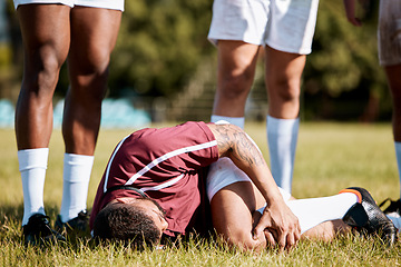 Image showing Knee pain, sports with injury and athlete outdoor, rugby and fitness with man, team and first aid. Medical emergency, wound and sport accident, training and exercise with help and injured person