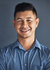 Image showing Face portrait, smile and business man in studio isolated on a blue background. Ceo, boss goals and happy, confident and proud male entrepreneur from Brazil with vision, mission and success mindset.