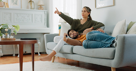 Image showing Relax, love and watching tv with couple on sofa for movie, streaming or television subscription. Happy, smile and peace with man on woman legs in living room at home for video, news or film together