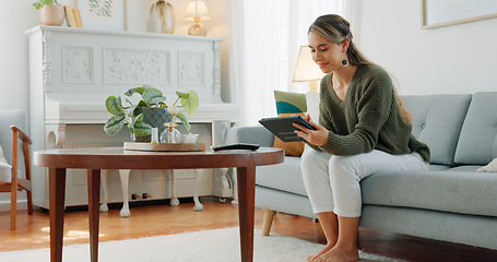 Image showing Internet, smile and woman with a tablet for communication, online reading and social media on the sofa in the living room of her house. Happy, relax and calm girl with technology for a mobile app