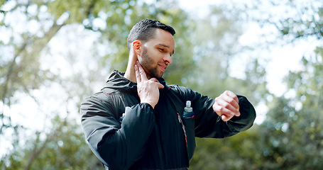 Image showing Man checking pulse in neck, smartwatch with fitness app and hiking on adventure trail in forest. Nature, workout and exercise for healthy athlete in woods with 5g, heart rate tracker and motivation.