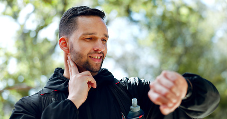 Image showing Fitness, man and watch check time in nature for exercise, workout or training in the outdoors. Happy athlete runner looking at smart watch monitoring heart rate, pulse or activity for healthy cardio