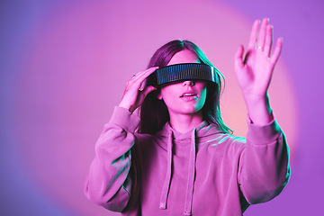 Image showing Woman, vr and futuristic cyberpunk glasses on metaverse app for online game or video on neon purple background. Virtual reality, future fashion and digital augmented reality google on model in studio