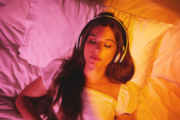 Image showing Gen z, headphones and woman sleeping with creative vaporwave lighting in a bedroom bed. Dreaming, music listening and web audio streaming of a female model resting eyes with makeup on a pillow