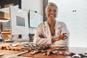 Image showing Senior optometrist woman, portrait and office with glasses, smile or frame design planning at desk. Happy optician, spectacle designer and excited face in workplace for pride, small business and goal