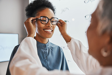 Image showing Glasses check, black woman and customer with store worker and optician looking at lense. Eye consulting, smile and eyewear assessment in a frame shop for vision test and prescription exam for eyes