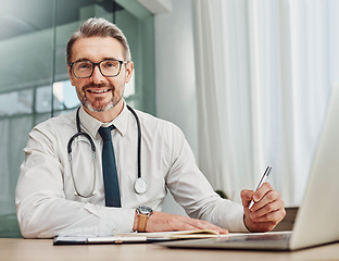 Image showing Senior doctor, writing and portrait of a hospital worker in a office doing medical research. Happiness, laptop and checklist of a wellness and health employee with a smile from clinic vision