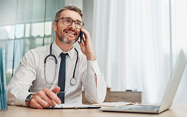 Image showing Phone call, laptop and male doctor doing a telehealth consultation in his office in the hospital. Technology, communication and senior man healthcare worker on a mobile conversation in medical clinic