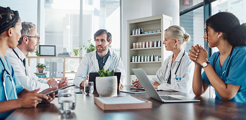 Image showing Meeting, team and doctors in discussion in the hospital conference room for collaboration. Teamwork, medical and group of healthcare workers talking about a diagnosis, strategy or treatment plan.