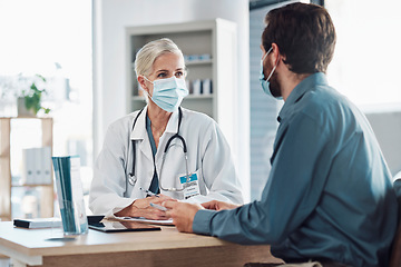 Image showing Consultation, covid and doctor with a man for healthcare, medical attention and service. Medicine, support and consultant with a face mask for virus while talking to a patient about health results