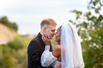 Image showing Portrait of kissing newlyweds, close-up