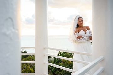 Image showing Portrait of a bride in a wedding dress in a gazebo with columns on the seashore