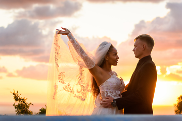 Image showing Portrait of newlyweds in the rays of the setting sun