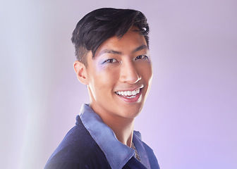 Image showing Makeup, smile and portrait of gay man from Indonesia with confidence isolated on purple background. Happy, aesthetic and lgbt fashion model with beauty in studio, non binary and gender neutral design