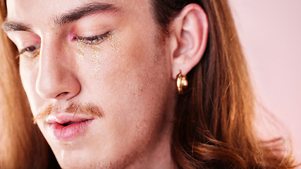 Image showing LGBTQ, makeup and gay man in a studio with a cyberpunk, androgynous and natural aesthetic. Creative, cosmetics and young queer male model with a cosmetic, glow and beauty face by a pink background.