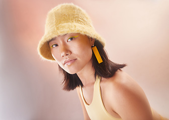 Image showing Asian woman, fashion and makeup with gen z and portrait, yellow aesthetic and edgy on studio background. Streetwear, beauty and cosmetics with style, female face and young model with fog or smoke