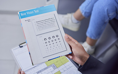 Image showing Optometry, consulting and hand with a vision test, document and paper for an eye exam. Consultation, ophthalmology and optician with an optical examination for a patient for eyesight and glasses