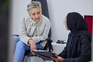 Image showing Optometry, consulting and woman with an optician for paperwork, medical background and communication. Healthcare, ophthalmology and senior patient with a Muslim doctor for information on eyesight