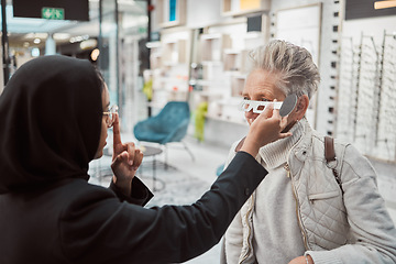 Image showing Optometry, Islamic woman and customer in store, glasses and healthcare for vision, retail an testing. Optometrist, mature female and Muslim lady help client, eyewear and optician with frames or sales